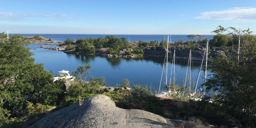Vy från en klippa med utsikt över vik och hav.