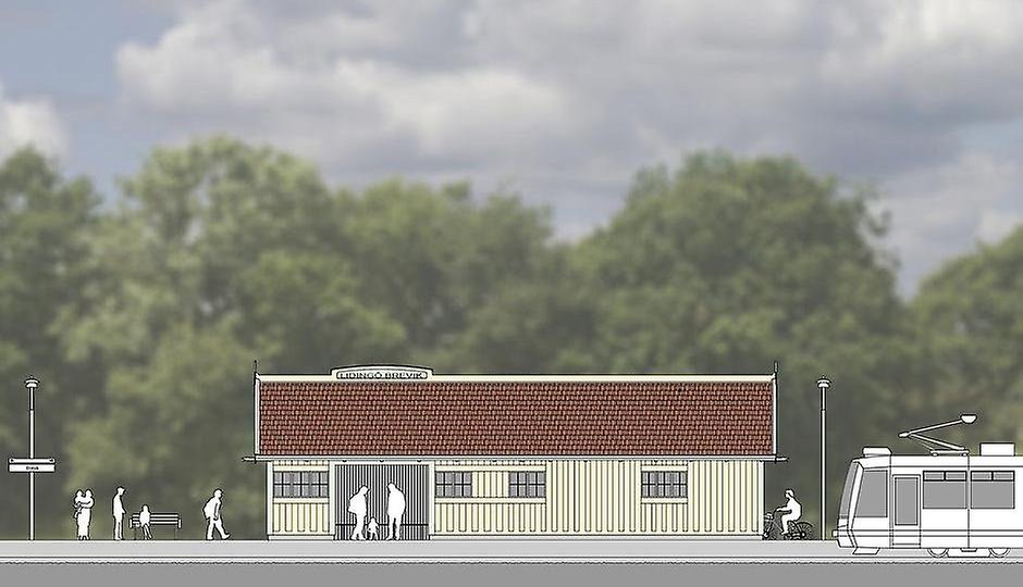 Gult hus med rött tak, folk på perrong och ett tåg som anländer.