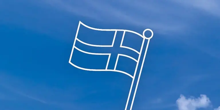 En vit flagga som vajar på den blå himlen.