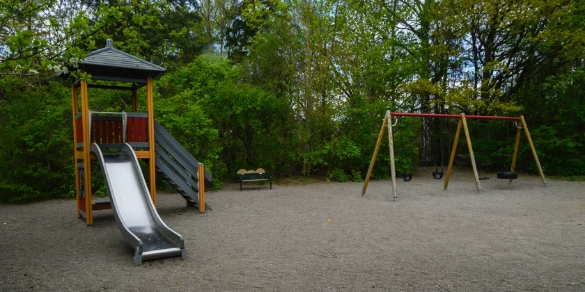 Lekpark med en rutschkana och en gungställning.