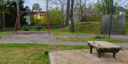 En lekpark med en gungställning och en sandlåda.