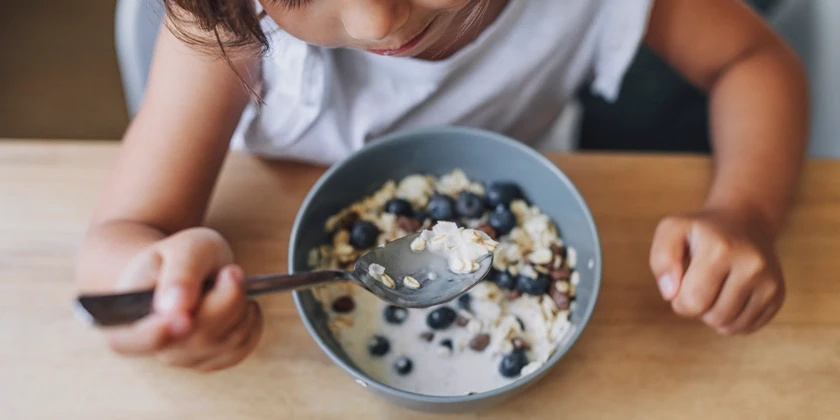 Barn äter mjölk och müsli