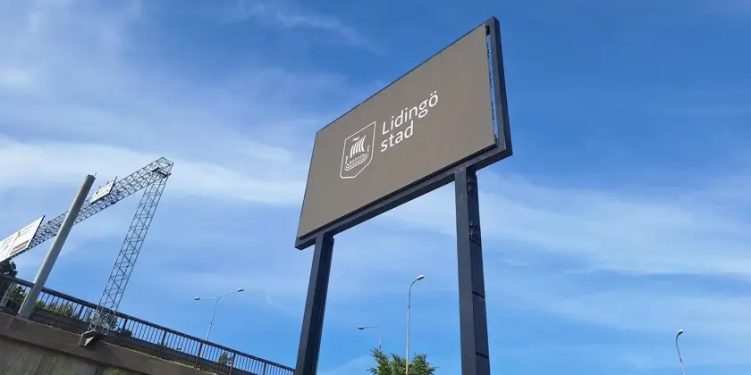 En digital skylt som står vid sidan av en Lidingöbron intill brofästet.