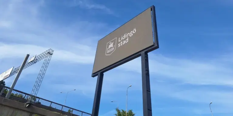 En digital skylt som står vid sidan av en Lidingöbron intill brofästet.