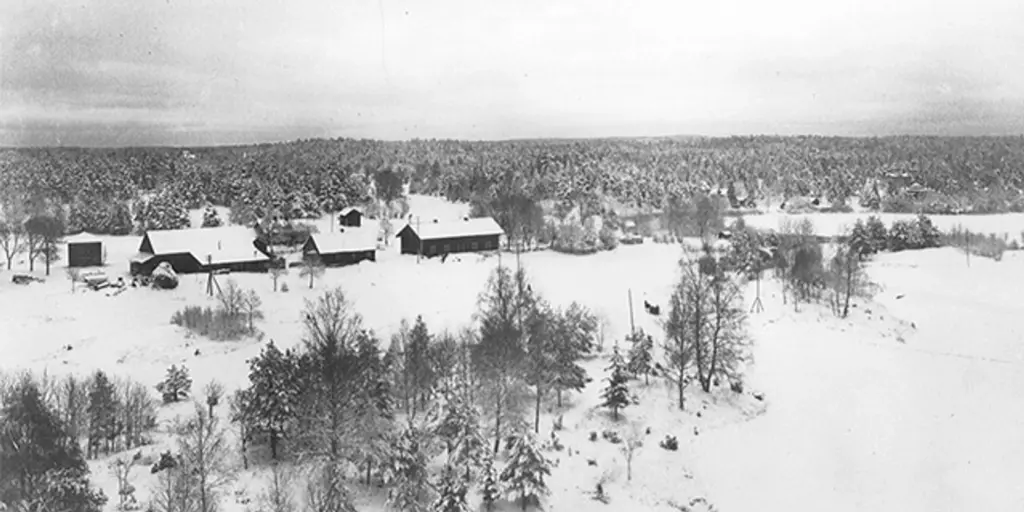 Ett svartvitt flygfoto över en gård med lantbruk.